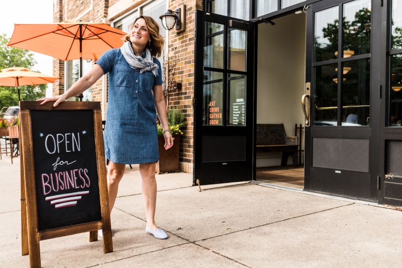 Business owner at her front door of business