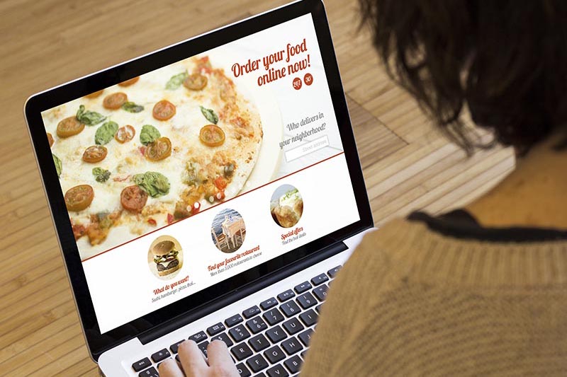 Woman viewing pizza restaurant for online ordering. 